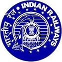 Circular blue logo of Indian Railways featuring a central steam locomotive emblem overlaid with the State Emblem of India, framed by a border of white stars and the organization's name written in both Devanagari script and English.