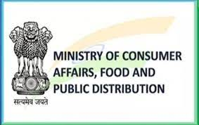 Logo of the Ministry of Consumer Affairs, Food and Public Distribution featuring the State Emblem of India (Ashoka Lion Capital) on the left with "Satyamev Jayate" written underneath, accompanied by the bold black text of the ministry name and a faint tricolor background brushstroke.